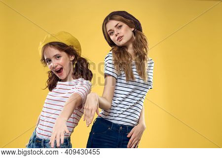 Cheerful Sisters In Hats Striped T-shirts Joy Lifestyle Yellow Background Family