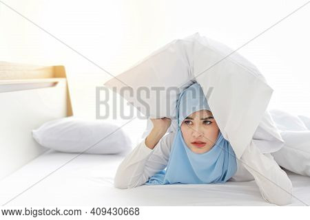 Oversleeping Asian Muslim Woman In Sleepwear Lying On Bed And Missing Ring Of Alarm Clock Waking Up.