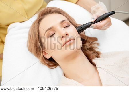Young Woman Receiving Rf Lifting Electric Facial Massage For Face Skin