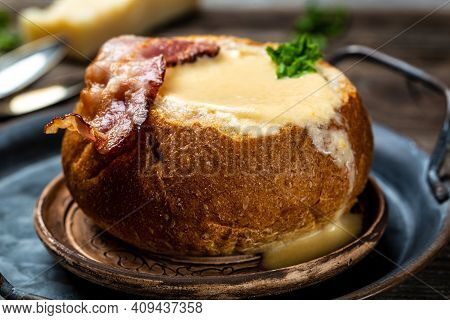 Homemade Broccoli And Cheddar Soup In A Bread Bowl. Cheese Cream Soup Served With Spoon. Food Recipe