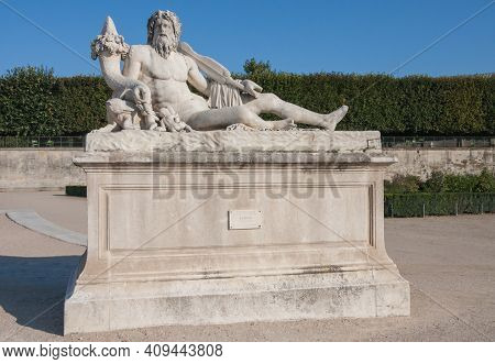 Le Tibre (the Tibor) Marble Statue In The Tuileries Garden On An Autumn Day With Clear Blue Sky In P