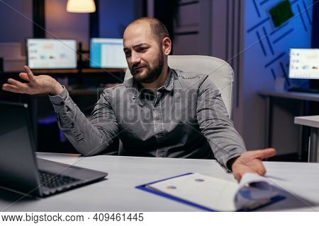 Stressed Entrepreneur Looking Confused At Laptop In The Course Of Overworking. Confused Businessman 