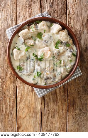Romanian Creamed Chicken Ciulama De Pui Closeup In The Bowl On The Table. Vertical Top View From Abo