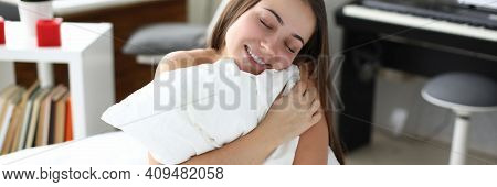 Happy Woman Sit In Bed And Hug White Pillow. Man Enjoy Soft Bedding And Smile. Sale Of Bed Linen And