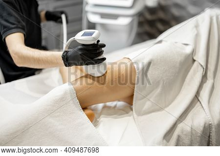 Doctor Doing Ultrasound Liposuction Procedure In Medical Clinic.