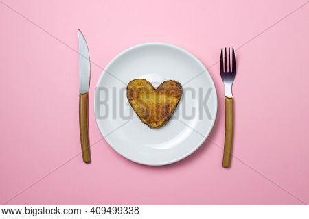 Heart-shaped Fried Potatoes. Fried Potatoes In A White Plate On A Pink Background. Love Of Food