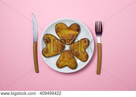 Heart-shaped Fried Potatoes. Fried Potatoes In A White Plate On A Pink Background. Love Of Food