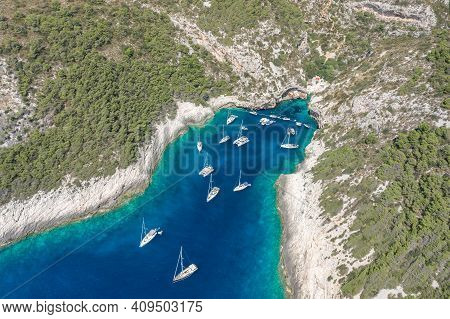 Aerial Drone Shot Of Yachts At Stiniva Cove Of Blue Adriatic Sea On Vis Island In Croatia Summer