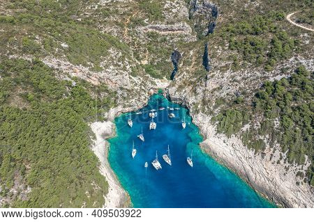 Aerial Drone Shot Of Yachts At Stiniva Cove Of Blue Adriatic Sea On Vis Island In Croatia Summer