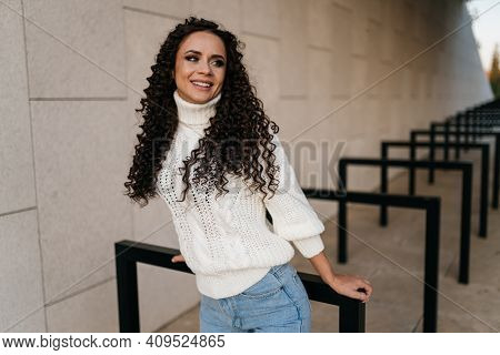 Naughty Look At The Girl Slightly Snr And Smiling At Someone Over Her Shoulder. High Quality Photo
