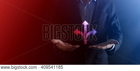 Businessman In A Suit Holds A Sign Showing Three Directions. In Doubt, Having To Choose Between Thre