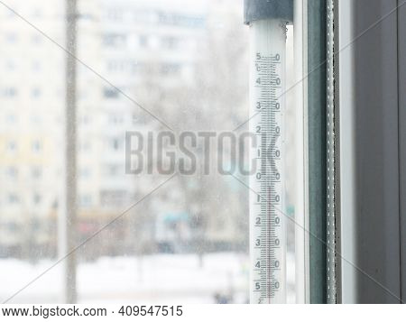 Below Zero On Window Thermometer In City In Snowfall, Outdoors, Closeup
