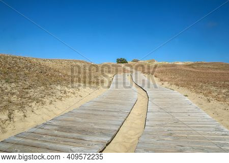 A Picture From The Curonian Spit (kursiu Nerija) National Park In Lithuania. The Wooden Tourist Path