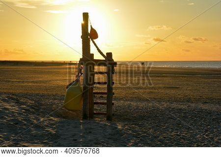 Rescue Equipment Hangs On Wooden Scaffolding At Sunset On Renesse Beach, Zeeland, Netherlands