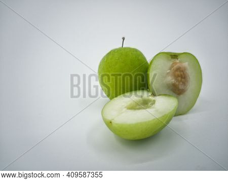 Indian Jujube Fruit Or Ziziphus Mauritiana Or Buah Bidara In A Rattan Bowl. Blurred Background
