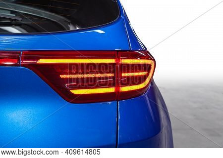 The Back Of A Blue Expensive Crossover Car:  Bumper, Trunk Lid, Taillight On The Back White Backgrou