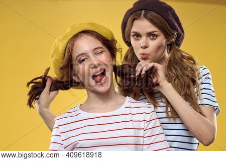 Cheerful Sisters In Hats Striped T-shirts Joy Lifestyle Yellow Background Family