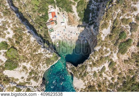 Aerial Overhead Drone Shot Of Tourists Swim Sunbath At Stiniva Beach On Vis Island In Croatia Summer