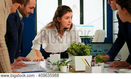Multiethnic Businesspeople Analysing Financial Project During Corporate Meeting. Team Of Employees G