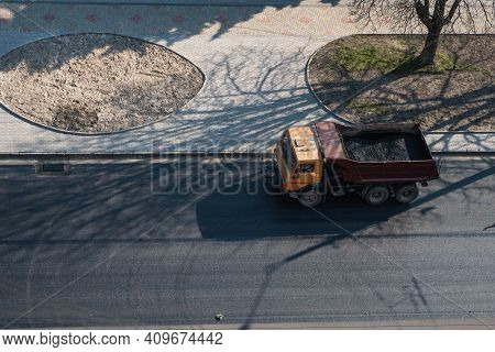 Truck With A Breakstone On A Road In The City During Road Construction Work.