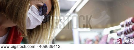 Young Woman In Medical Mask, Sunglasses, Red Jacket Points Her Finger At Jewelry Display. Social Dis