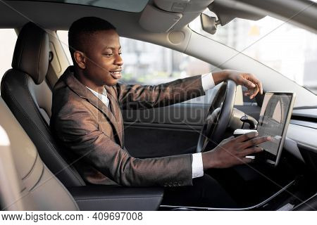 Smiling African American Young Businessman, Dirnking Coffee To Go During Break, Sitting In The Cabin