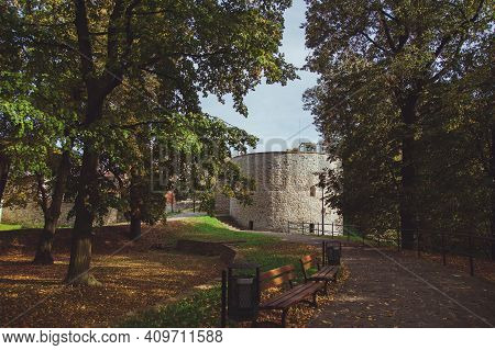 Beautiful Park In The Castle Of The City Of Przemysl On A Sunny Clear Day Against A Bright Sky. Tall