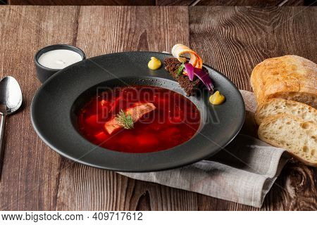 Ukrainian Traditional Borshch. Beetroot And Cabbage Soup With Meat Served With Sour Cream And Sliced