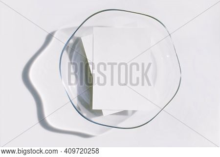 Mockup Poster Or Flyer For Presentation, White Paper In The Glass Tray And Shadow On A Gray Backgrou