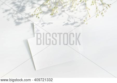 Mockup Poster Or Flyer For Presentation White Sheets Of Paper With A Branch Of White Flowers And Sha