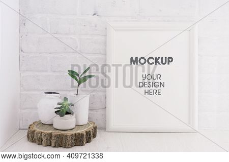Empty Picture Mockup With Wooden Frame On White Brick Wall Background With Succulents Plants On A Wo