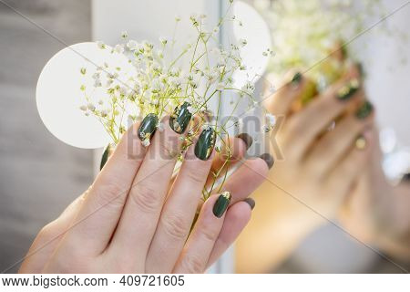 Hands With Beautiful Hakki Manicure And Gold Foil. A Woman Is Holding A Branch With White Flowers. B