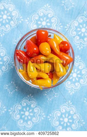 Pickled red and yellow hot chili peppers