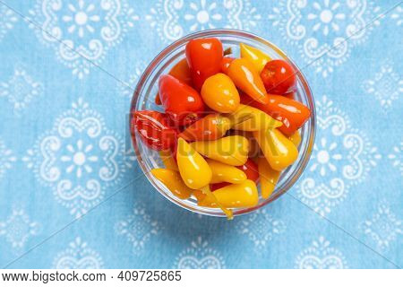Pickled red and yellow hot chili peppers