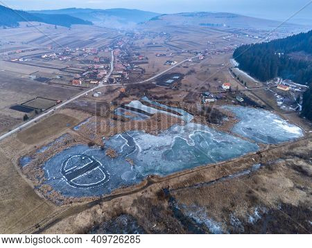 Fitod, Romania- 24 February 2021: Aerial View, Small Frozen Lake Near The Village.