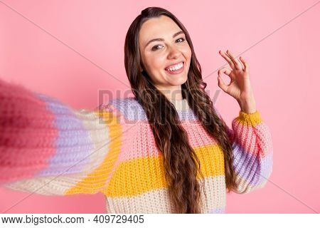 Self-portrait Of Attractive Cheerful Brown-haired Girl Influencer Showing Ok-sign Isolated Over Pink