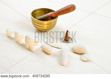Three Elephantes Made Of Stone And Singing Bowl On White Wooden Background. Meditation And Relaxatio