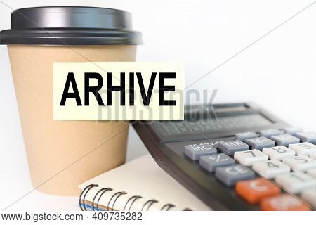 Arhive. Text On Yellow Sticker. Sticker Pasted On A Cup Of Coffee On A White Background. Business Co