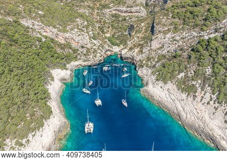 Aerial Drone Shot Of Yachts At Stiniva Cove Of Blue Adriatic Sea On Vis Island In Croatia Summer