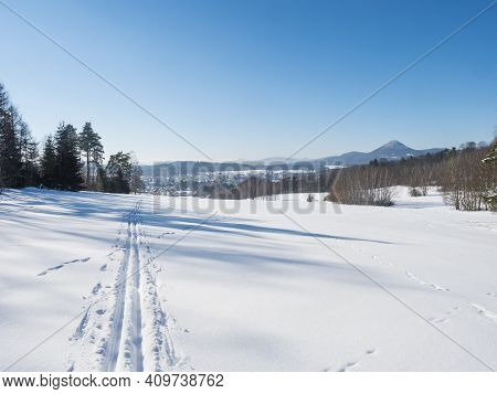 Winter Landscape With View Of Village Town Cvikov And Ski Run Trail On Snow-covered Fields And Snowy