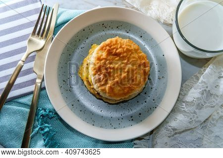Sausage Egg And Cheese Biscuit Breakfast Sandwich With Glass Of Milk