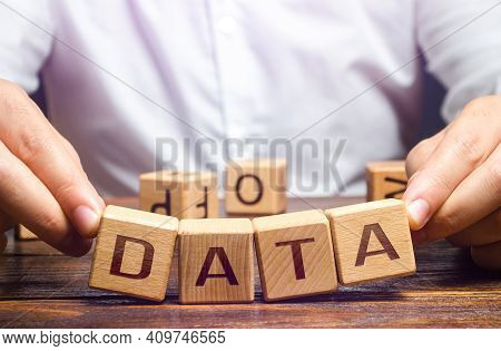 The Man Tries To Pick Up Blocks With The Word Data. Digital Data Integrity And Security Vulnerabilit