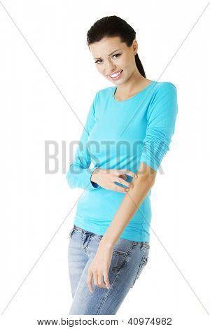 Young beautiful woman scratching her self. Isolated on white