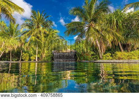 Summer Vacation At A Luxury Resort With Infinity Pool With Amazing Green Palm Trees Under Blue Sky. 