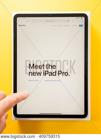 Paris, France - Feb 4, 2021: Pov Male Hand Holding Looking At The New Apple Computers Ipad Pro With 