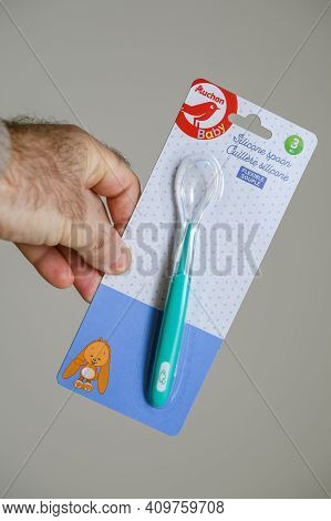 Paris, France - Nov 16, 2018: Pov Male Hand Holding Looking At The New Unpackaged Auchan Baby Spoon 
