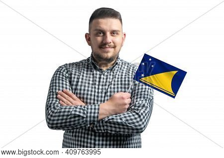 White Guy Holding A Flag Of Tokelau Smiling Confident With Crossed Arms Isolated On A White Backgrou