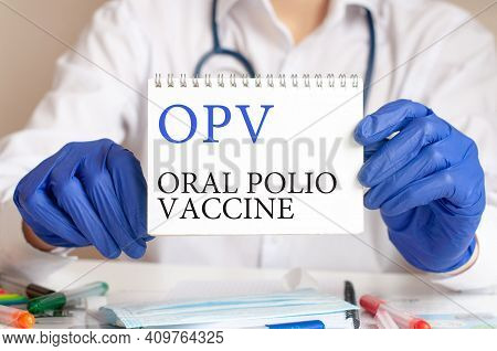 Doctor Holding A Tablet With Text: Opv. Opv - Oral Polio Vaccine, Medical Concept.