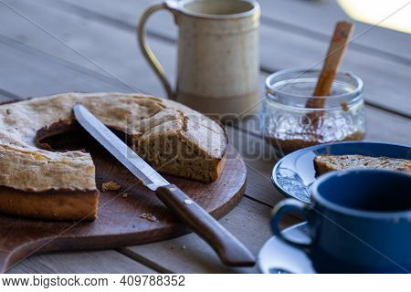 Banana Bread With Coffee Tea And Sweet Marmalade Jam And Knife On Wooden Table Outdoors Breakfast