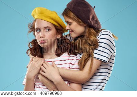 Mom And Daughter Striped T-shirts Hugs Fun Lifestyle Blue Background